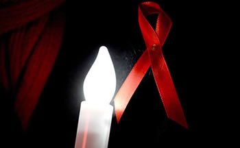 Lazo rojo y vela contra el sida